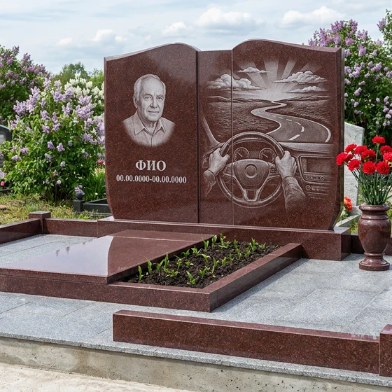 Гранитный памятник дальнобойщику в виде раскрытой книги с рулём и трассой